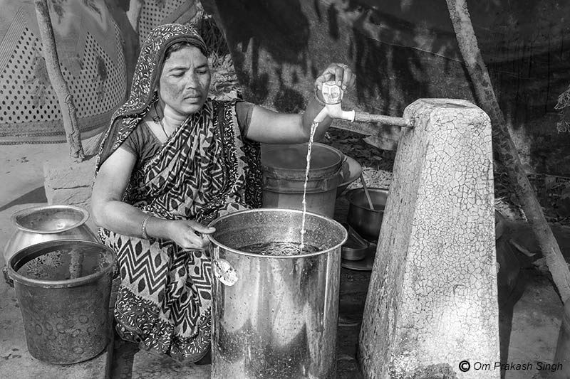 Collecting drinking water from an FHTC supplied by multi-village scheme  under Jal Jeevan Mission in Jharkhand, India